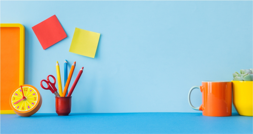 Colorful office supplies on a blue background.