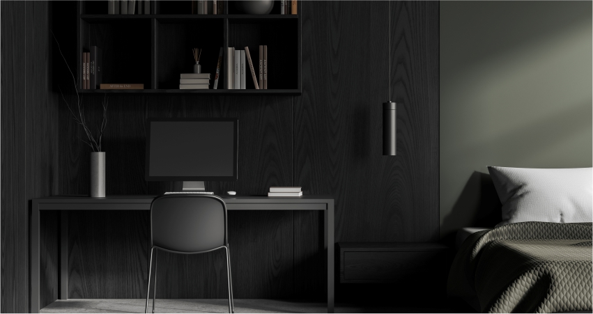 A black bedroom with a desk and bookshelf.