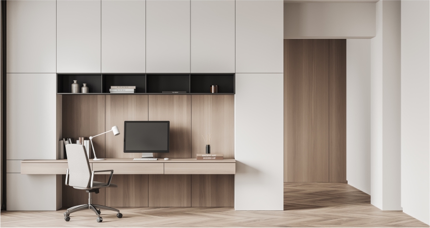 A room with a wardrobe, desk and chair.