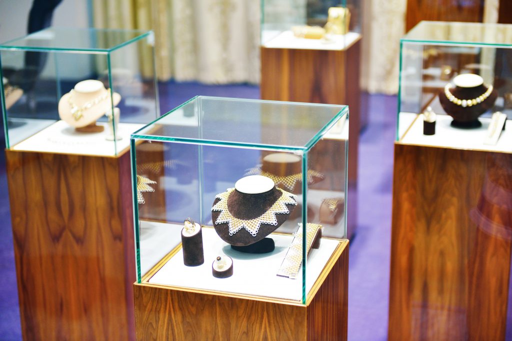 A display of jewelry in a glass case.