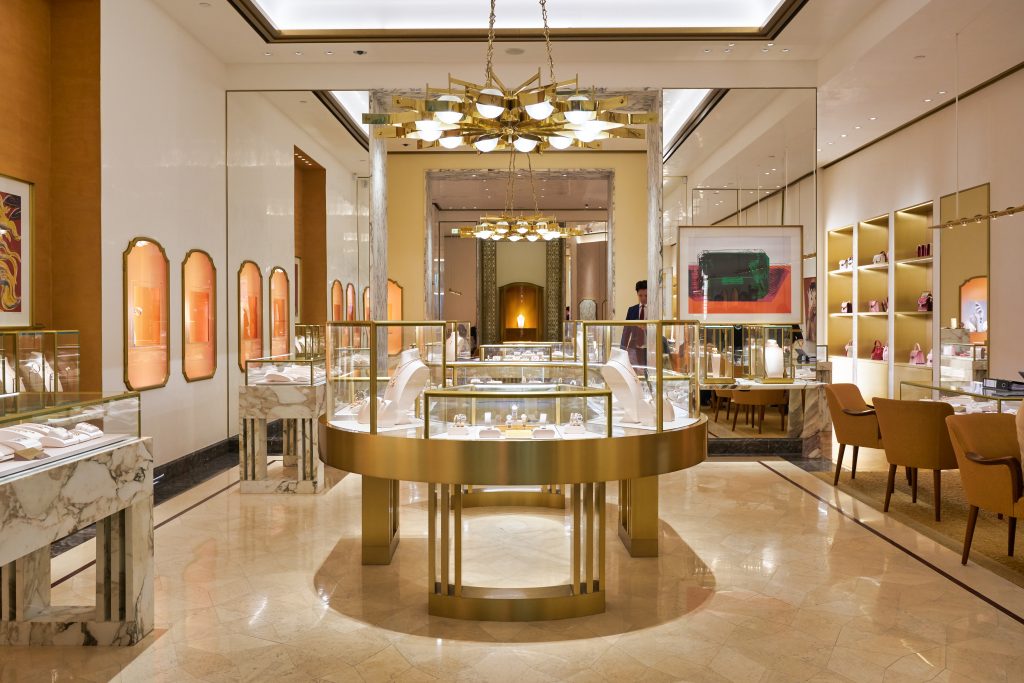 The interior of a jewelry store with gold accents.