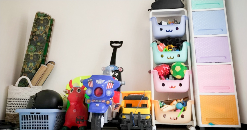 A variety of children's toys and items neatly organized on shelves and in storage bins.