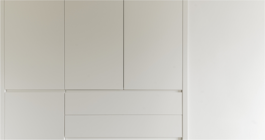 A minimalist white cupboard with a clean, modern design.