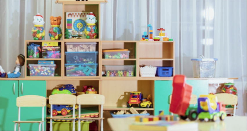 A bright and colorful children's playroom filled with toys, shelves, and small chairs.