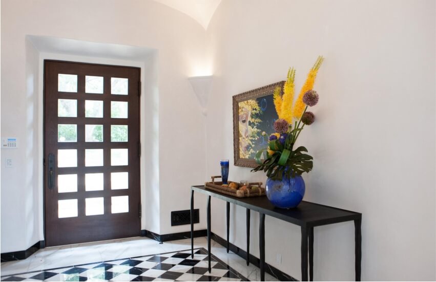 Sophisticated entry with decorative black and white tiles