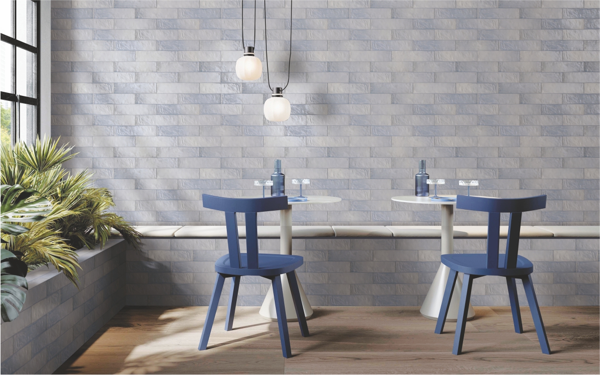 Café-style interior featuring Ash Lustre Smoky Subway wall tiles in 65x260 mm size with matte finish, adding a soft grey tone and textured look perfect for modern dining or living spaces. 