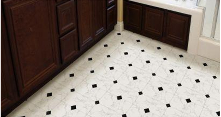 Kitchen floor with white marble tiles featuring black diamond accents and dark cabinets