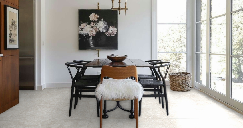Bright dining room with light floor tiles, dark wooden table, and floral wall art