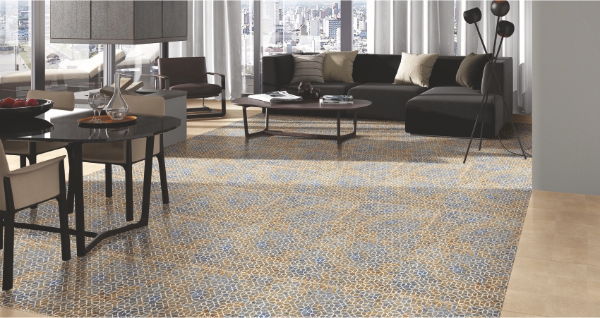 Spacious modern living room with mosaic-patterned floor tiles in blue and gold tones, complemented by contemporary furniture