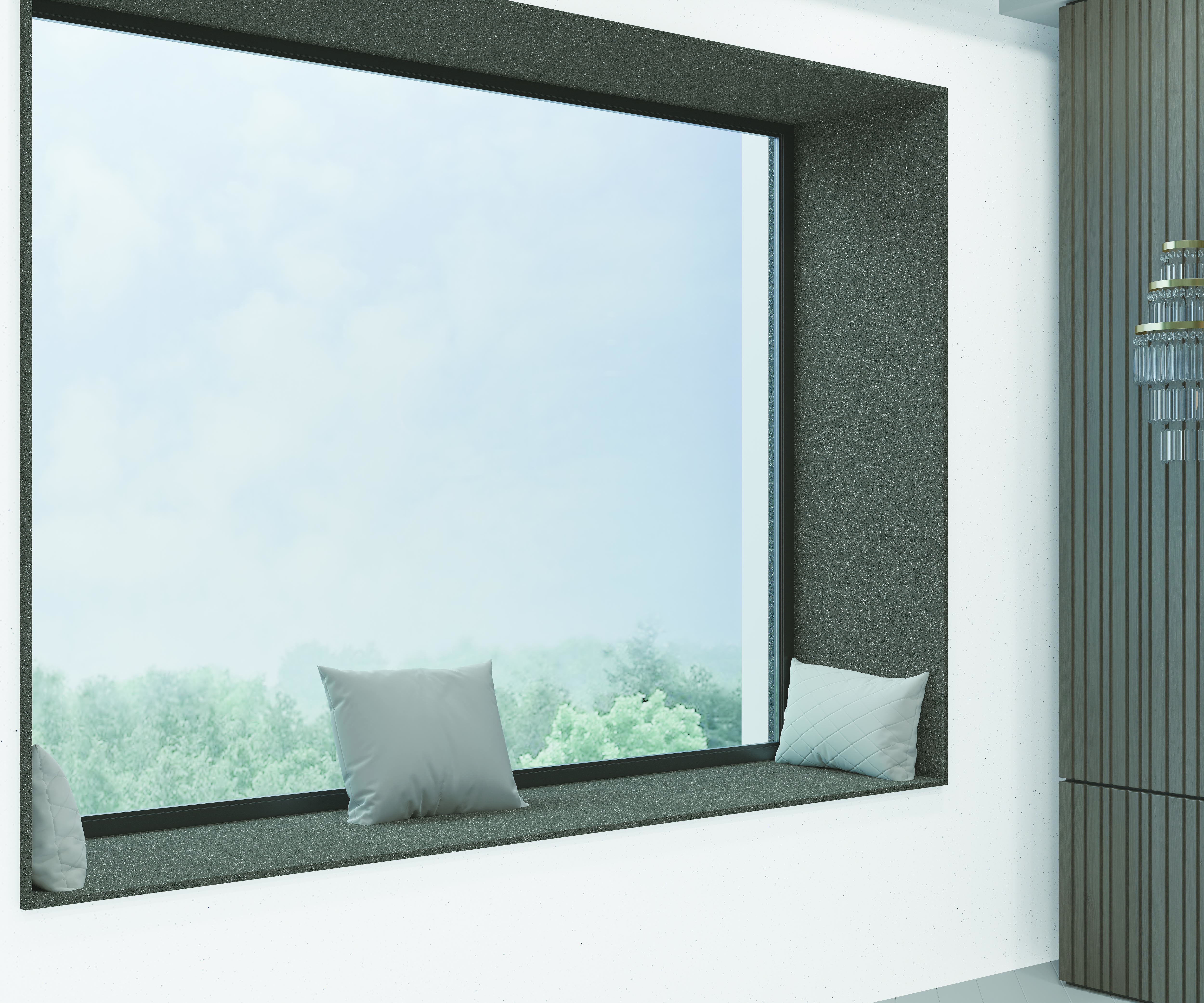 A large window with a tiled dark gray seating area, cushions, and a scenic outdoor view