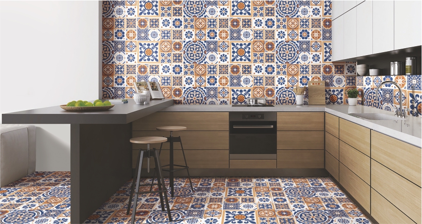 A stylish kitchen featuring vibrant blue and orange patterned tiles on the walls and floor