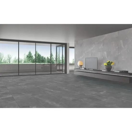 A sleek living room featuring large gray floor tiles, a glass wall, and minimalist design